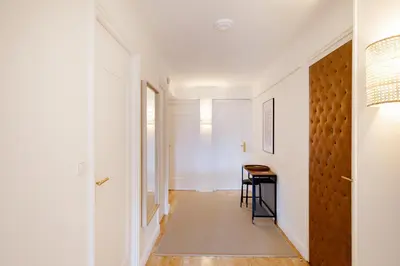 a hallway with a door and a table in a room at Super Californie YourHostHelper in Cannes