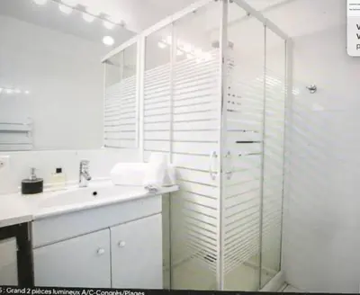 a white bathroom with a sink and a shower at Écrin de douceur à 300m de la Croisette Calme in Cannes