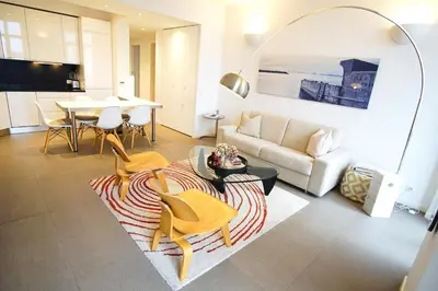 a white kitchen with a white table and chairs at Ref ANTIBES - Palmes d'Or Properties in Cannes