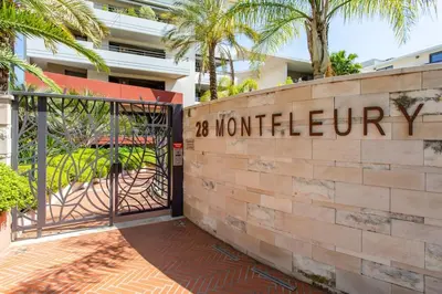 a gate to the entrance to a building with a sign that reads hotel up at C2 - 2 BDR Montfleury - Pool, Garage, Terrace & AC in Cannes