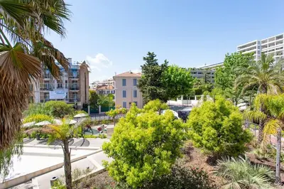 a view of a park with trees and buildings at C2 - 2 BDR Montfleury - Pool, Garage, Terrace & AC in Cannes