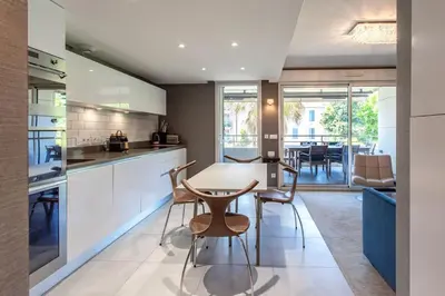 a kitchen and dining room with a table and chairs at C2 - 2 BDR Montfleury - Pool, Garage, Terrace & AC in Cannes