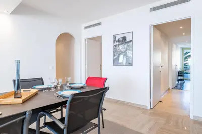 a dining room with a table and chairs at PANORAMIC SEA VIEW - 2-Br Apartment Mouré Rouge in Cannes