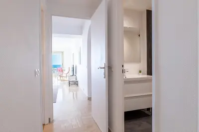 a white kitchen with a sink and a counter at PANORAMIC SEA VIEW - 2-Br Apartment Mouré Rouge in Cannes