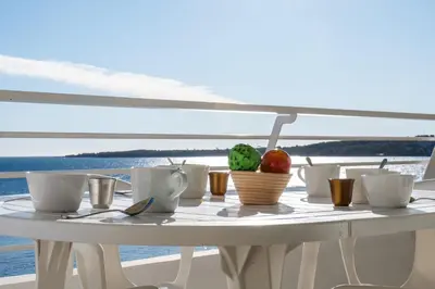 a white table with cups and apples on it at PANORAMIC SEA VIEW - 2-Br Apartment Mouré Rouge in Cannes