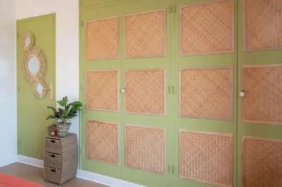 a room with a green wall with doors at C5 - 2 BDR Blvd Carnot - 10 min Palais - AC & Terrace Sea View in Cannes