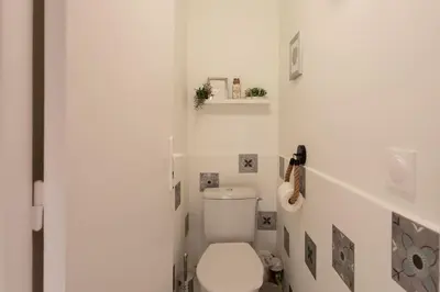 a bathroom with a white toilet in a room at C5 - 2 BDR Blvd Carnot - 10 min Palais - AC & Terrace Sea View in Cannes
