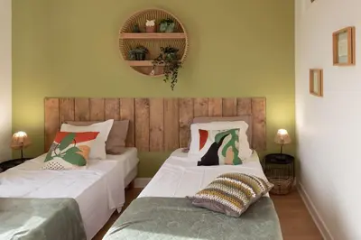 two beds sitting next to each other in a bedroom at C5 - 2 BDR Blvd Carnot - 10 min Palais - AC & Terrace Sea View in Cannes
