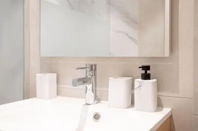 a bathroom with a sink with two rolls of paper towels at Amazing Apartment With Private Terrace & Full Air Conditioning - Walk To The Beach, La Croisette! - Latour Maubourg 18 by Halldis in Cannes