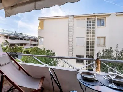 a balcony with a table and chairs and a building at Apartment Le Marlyne 2-3 by Interhome in Cannes