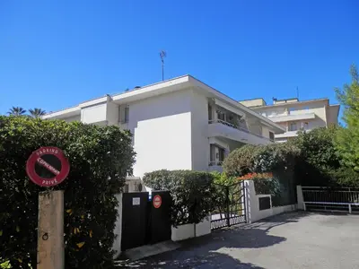 a white building with a sign in front of it at Apartment Le Marlyne 2-3 by Interhome in Cannes