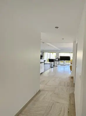 an empty hallway with a living room and a piano at Charming 2 room , 52 m2, very spacious, bright and near sea Martinez hotel in Cannes