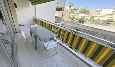 a table and chairs on a balcony with a view at Charming 2 room , 52 m2, very spacious, bright and near sea Martinez hotel in Cannes