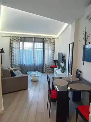 a living room with a couch and a table at Foras Urban Living à 2 pas du festival in Cannes