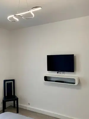 a flat screen tv on a white wall at Foras Urban Living à 2 pas du festival in Cannes