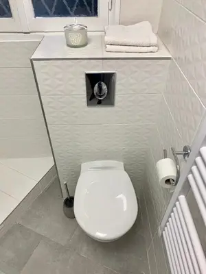 a bathroom with a white toilet with a counter at Foras Urban Living à 2 pas du festival in Cannes