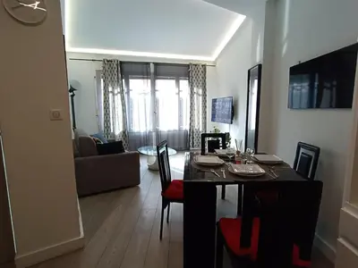a kitchen and living room with a table and chairs at Foras Urban Living à 2 pas du festival in Cannes