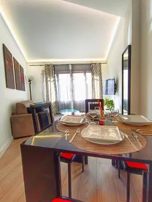 a dining room with a table and a living room at Foras Urban Living à 2 pas du festival in Cannes
