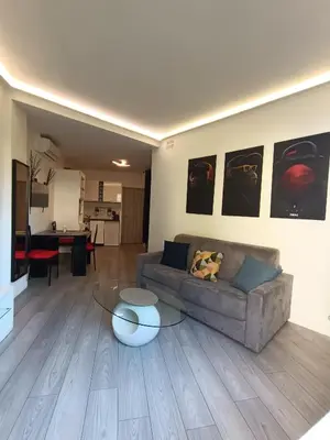 a living room with a couch and a table at Foras Urban Living à 2 pas du festival in Cannes