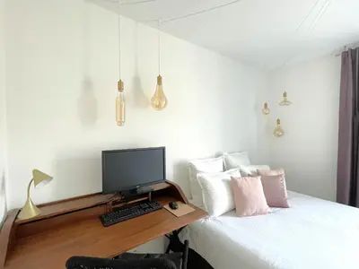 a bedroom with a desk with a computer on a bed at Alba DeLuxe - 3 Bedroom Pointe Croisette, by Welcome to Cannes in Cannes