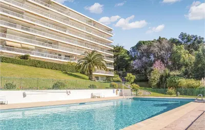 a swimming pool in front of a building at Beautiful Apartment In Cannes With Wifi in Cannes
