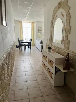 a living room with a tile floor and a table at Cannes : Agréable et lumineux appartement vue mer in Cannes