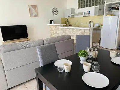 a living room with a table and a couch at Cannes : Agréable et lumineux appartement vue mer in Cannes