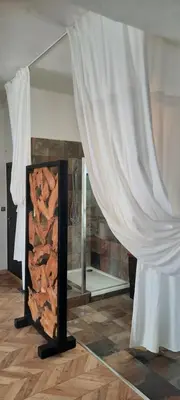 a room with a fireplace with a white curtain at Appartement Loft ATYPIQUE et ravissant de 60 m2 Nouveau in Cannes