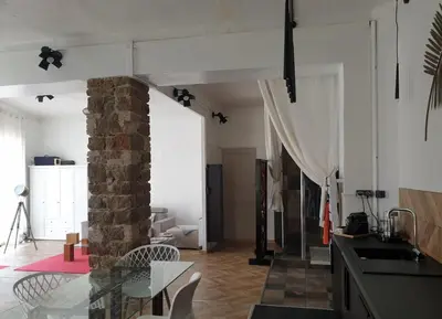 a kitchen and living room with a glass table at Appartement Loft ATYPIQUE et ravissant de 60 m2 Nouveau in Cannes