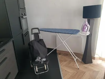 a blue table in a room with a bag and shoes at Appartement Loft ATYPIQUE et ravissant de 60 m2 Nouveau in Cannes