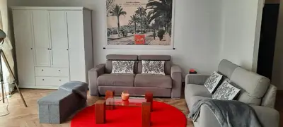 a living room with a couch and a table at Appartement Loft ATYPIQUE et ravissant de 60 m2 Nouveau in Cannes