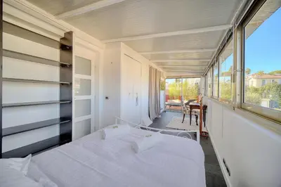 a bedroom with two beds and a large window at IMMOGROOM -Rooftop 150m2 -Terrace 150m2 -Parking -Wifi - AC in Cannes