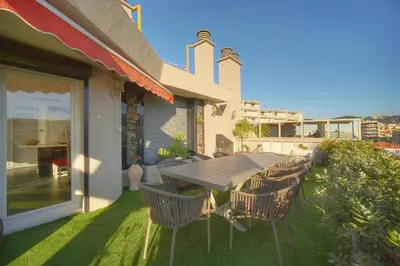 a patio with a table and chairs on a balcony at IMMOGROOM -Rooftop 150m2 -Terrace 150m2 -Parking -Wifi - AC in Cannes
