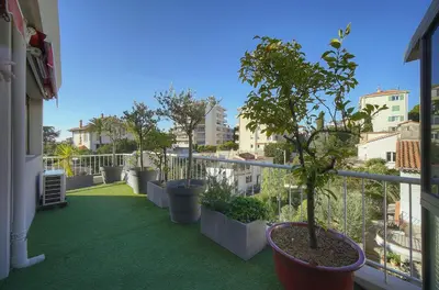 a balcony with potted plants on a building at IMMOGROOM -Rooftop 150m2 -Terrace 150m2 -Parking -Wifi - AC in Cannes