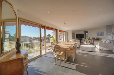 a large living room with a table and chairs at IMMOGROOM -Rooftop 150m2 -Terrace 150m2 -Parking -Wifi - AC in Cannes