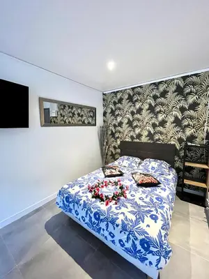 a bedroom with a blue and white bed with flowers on it at Luxury Dreams Balneo in Le Cannet