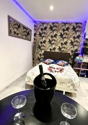 a room with a bed and two wine glasses at Luxury Dreams Balneo in Le Cannet