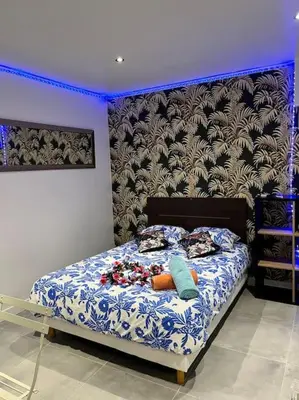 a bedroom with a bed with blue lights on it at Luxury Dreams Balneo in Le Cannet