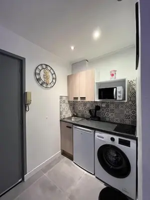 a kitchen with a washing machine and a microwave at Luxury Dreams Balneo in Le Cannet