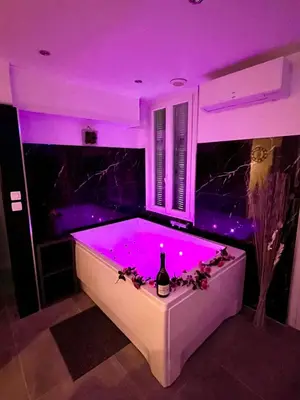 a bathtub with purple lighting in a room at Luxury Dreams Balneo in Le Cannet