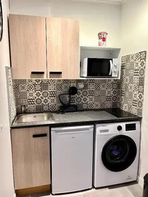 a kitchen with a washing machine and a microwave at Luxury Dreams Balneo in Le Cannet