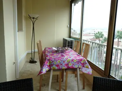 a dining room table with a flowered table cloth on it at Spacious studio in the center of Cannes nice terrace easy walk to the Croisette and Palais - 1923 in Cannes