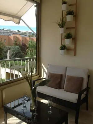 a living room with a couch and a balcony at Spacious studio in the center of Cannes nice terrace easy walk to the Croisette and Palais - 1923 in Cannes