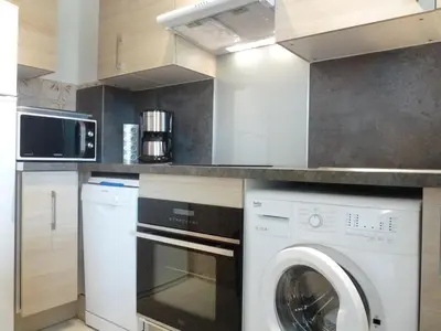 a kitchen with a washing machine and a washer at Spacious studio in the center of Cannes nice terrace easy walk to the Croisette and Palais - 1923 in Cannes