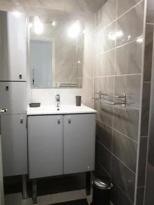 a white bathroom with a sink and a mirror at Spacious studio in the center of Cannes nice terrace easy walk to the Croisette and Palais - 1923 in Cannes
