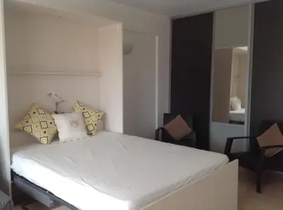a bedroom with a white bed with pillows on it at Spacious studio in the center of Cannes nice terrace easy walk to the Croisette and Palais - 1923 in Cannes