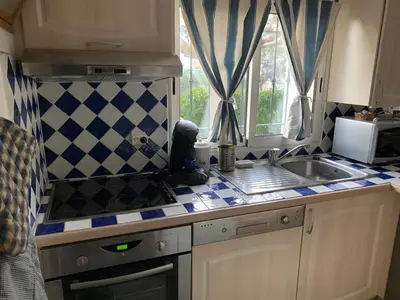 a small kitchen with a sink and a window at STUDIO classé 3 étoiles 10 mn Cannes in Le Cannet