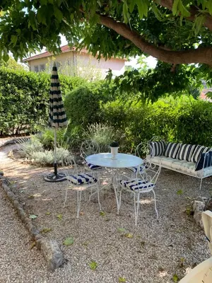 a table and chairs and a table and a bench at STUDIO classé 3 étoiles 10 mn Cannes in Le Cannet