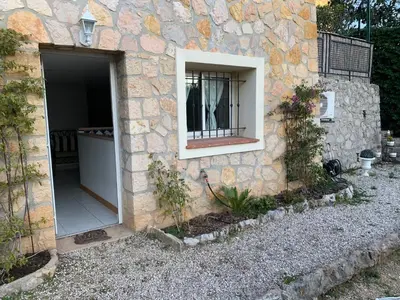 a stone building with a door and a window at STUDIO classé 3 étoiles 10 mn Cannes in Le Cannet