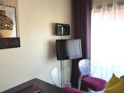 a room with a tv and a desk with a chair at Stylish one bedroom apartment in Central Cannes just off the Croisette and near beaches - 680 in Cannes